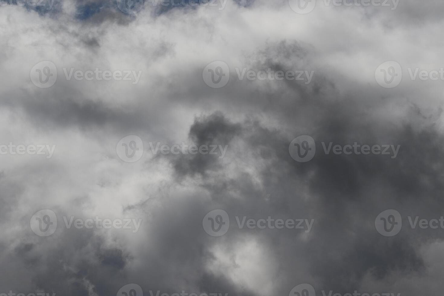 Cloudscape scenery, overcast weather above dark blue sky. Storm clouds floating in a rainy dull day with natural light. White and grey scenic environment background. Nature view. photo