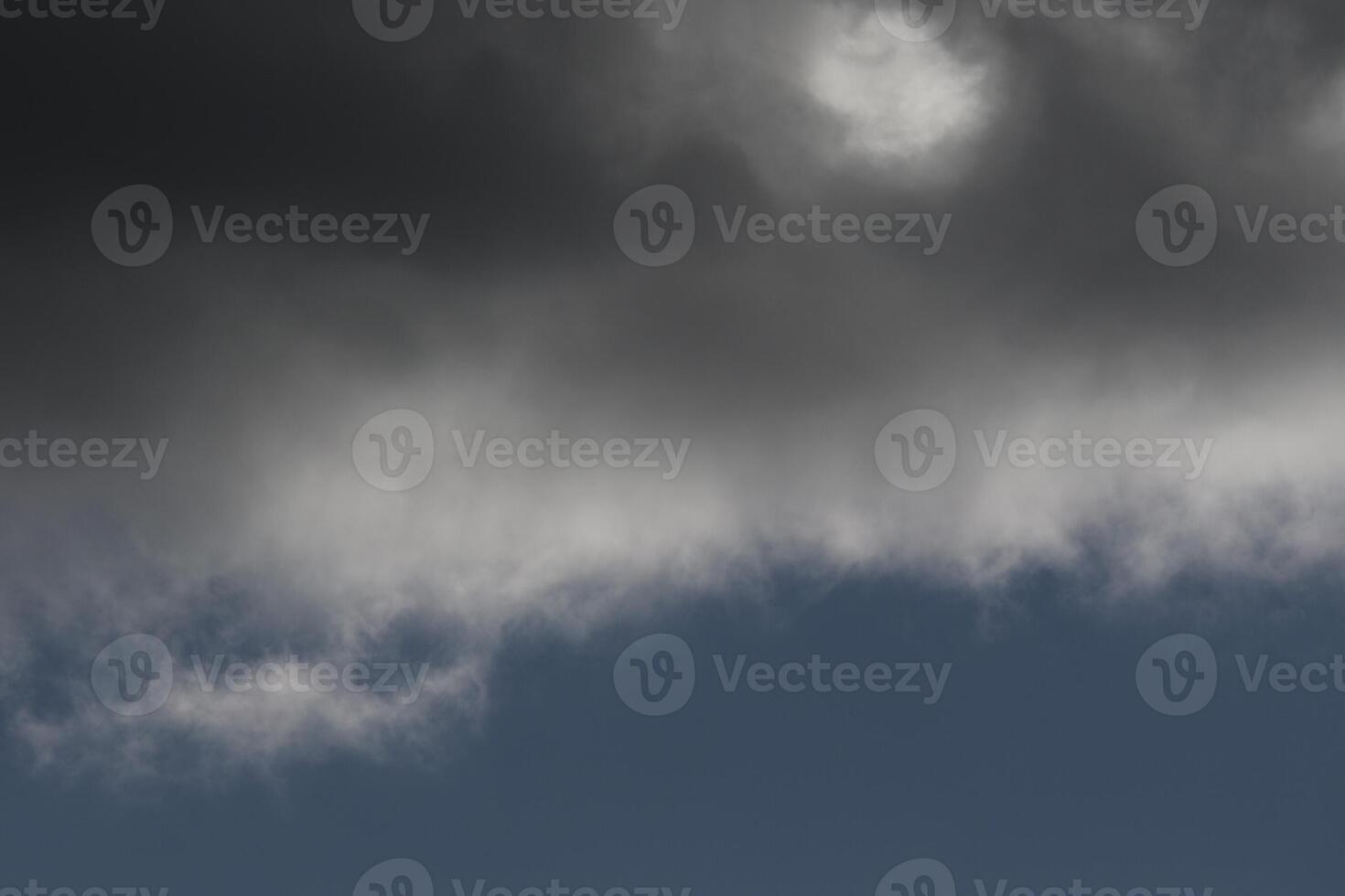 Cloudscape scenery, overcast weather above dark blue sky. Storm clouds floating in a rainy dull day with natural light. White and grey scenic environment background. Nature view. photo