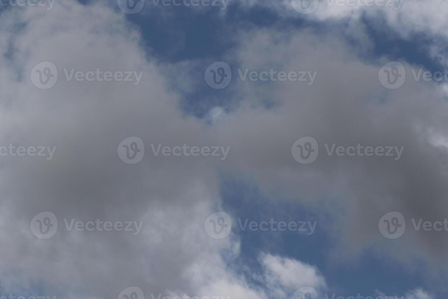 Cloudscape scenery, overcast weather above dark blue sky. Storm clouds floating in a rainy dull day with natural light. White and grey scenic environment background. Nature view. photo