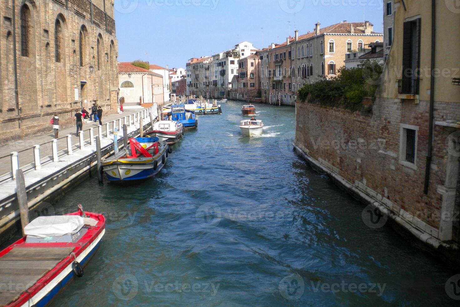 Venice Grand Canal, with its iconic winding waterway flanked by historic buildings and bustling activity, epitomizes the charm and allure of the enchanting city of Venice photo