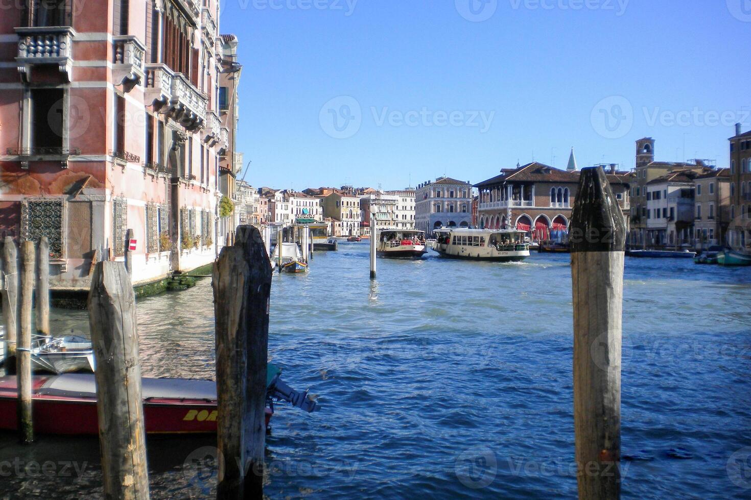 Venice Grand Canal, with its iconic winding waterway flanked by historic buildings and bustling activity, epitomizes the charm and allure of the enchanting city of Venice photo
