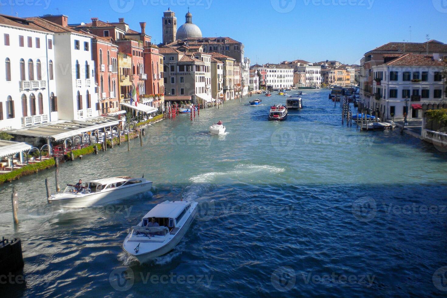 Venice Grand Canal, with its iconic winding waterway flanked by historic buildings and bustling activity, epitomizes the charm and allure of the enchanting city of Venice photo