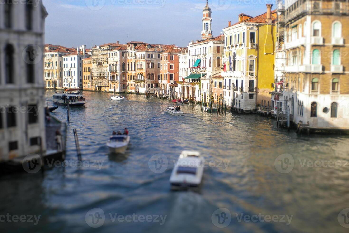 Venice Grand Canal, with its iconic winding waterway flanked by historic buildings and bustling activity, epitomizes the charm and allure of the enchanting city of Venice photo