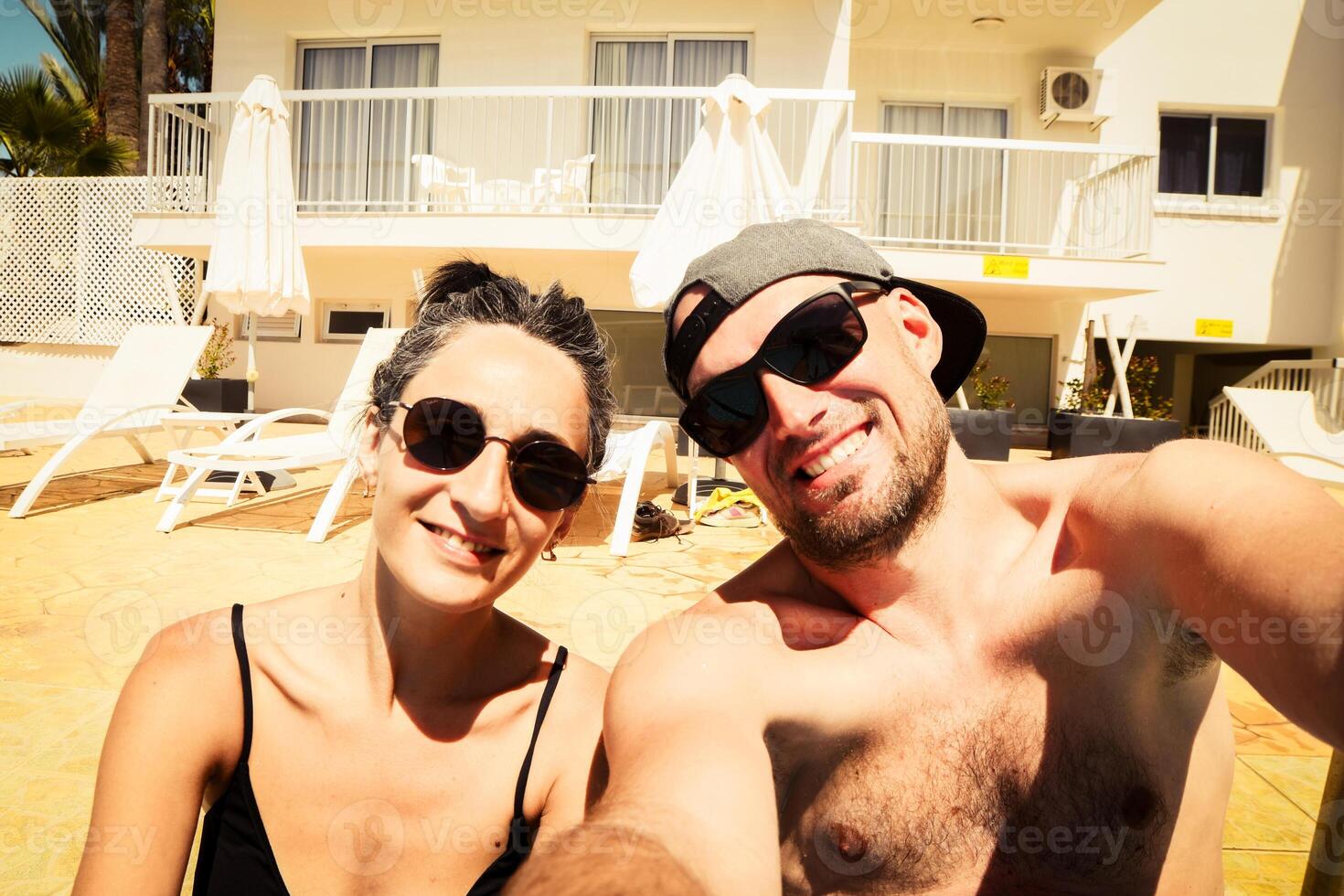 Happy traveling couple making selfie sea background . Sunny summer holidays. Romantic mood. Stylish sunglasses. Happy laughing emotional faces hipster multiracial. Cyprus holiday photo