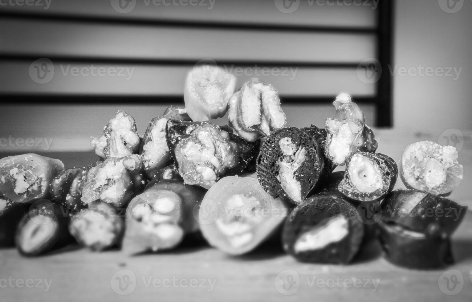 Black and white Macro close up of Various types of sliced peaces of Churchkhela with bank space background. Georgian fruit snacks concept. photo