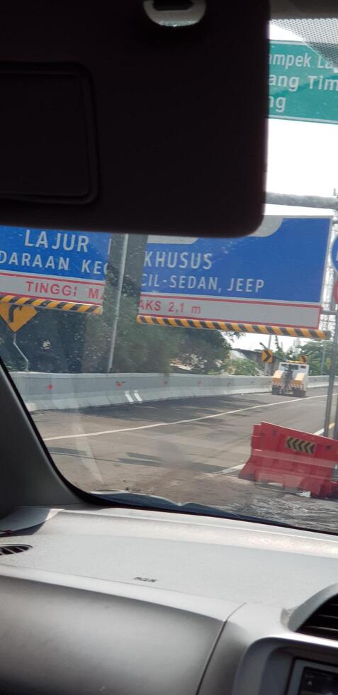 Bekasi, Indonesia in July 2020. A passenger car photographing the vehicle size limitation portal on the Japek Elevated Toll Road photo