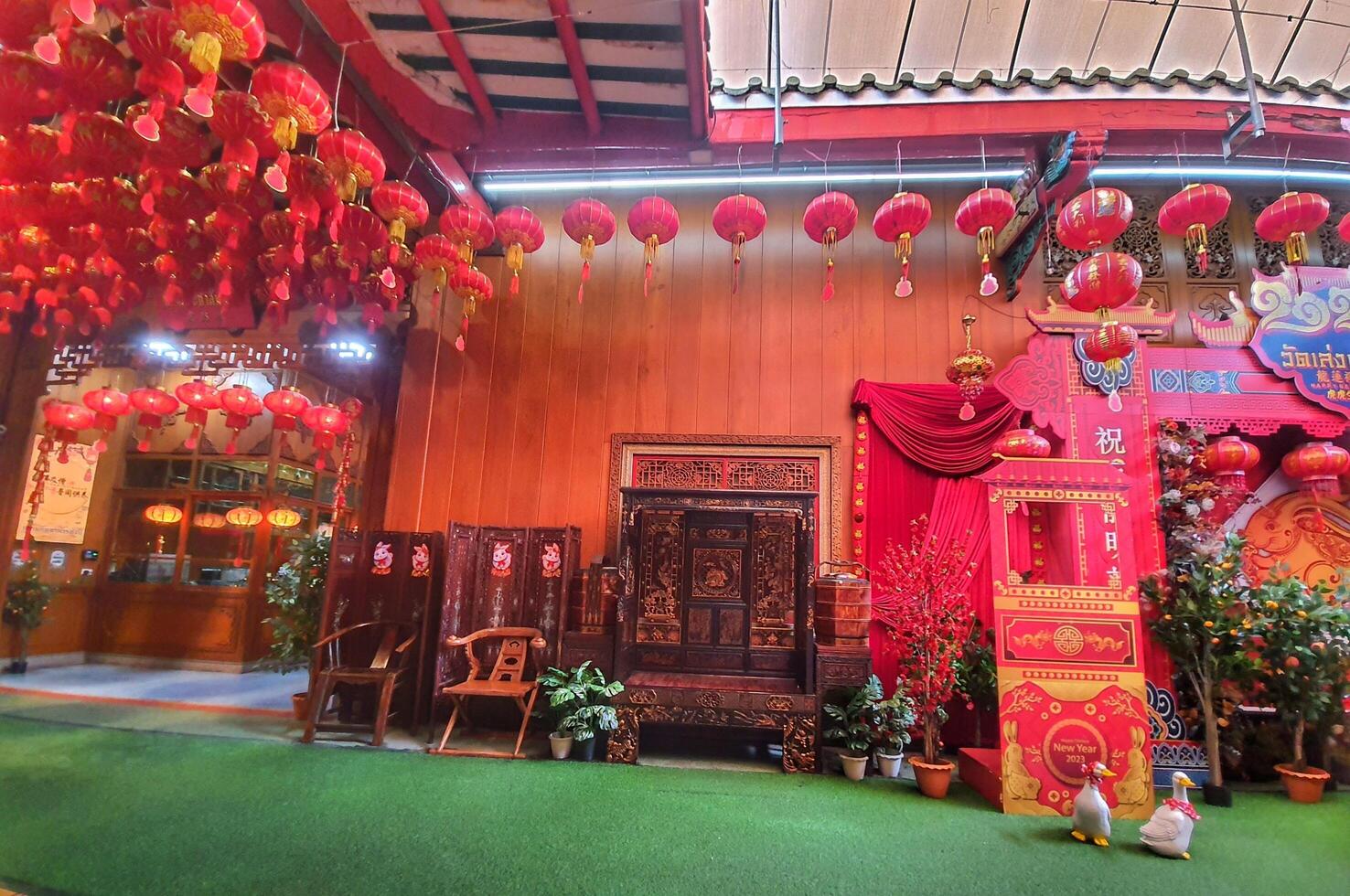 Bangkok, Thailand on July 22, 2023. The interior of the photo spot at the Wat Mangkon Kamalawat temple is filled with red decorations and the year of the rabbit logo.