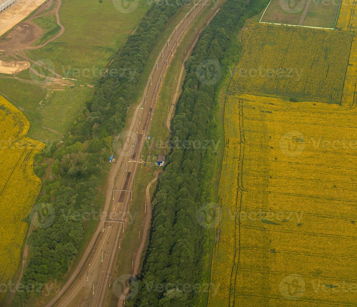 Land view through the airplane window. Fields, roads, rivers from a bird's eye view. Porthole. Look out the window of a flying plane. Top view of the ground photo