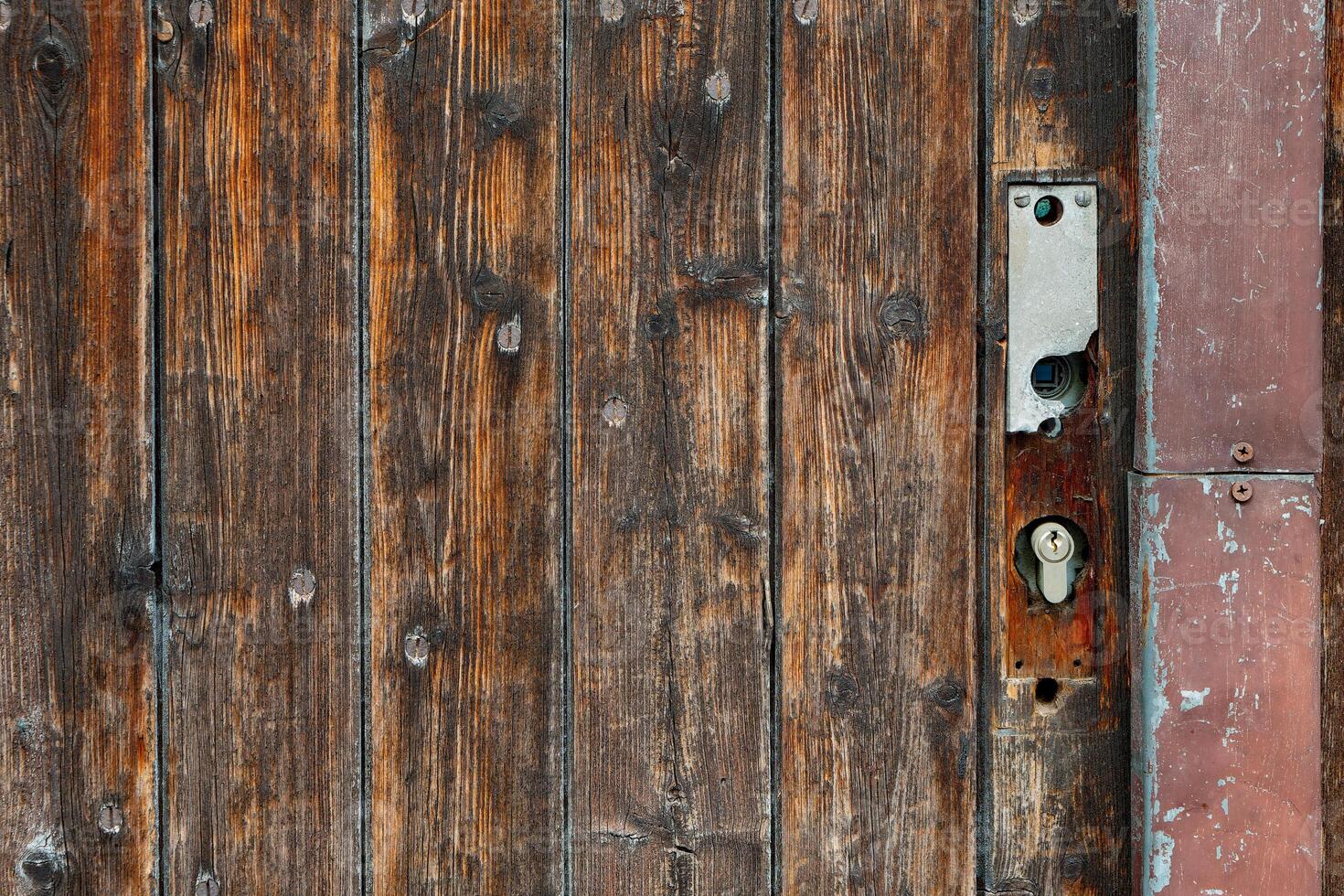 wooden door with a rusty lock photo