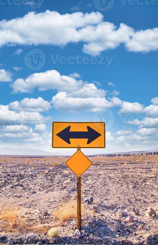 Direction sign in the desert under a blue sky. Concept of uncertain, risk, choice, decision photo