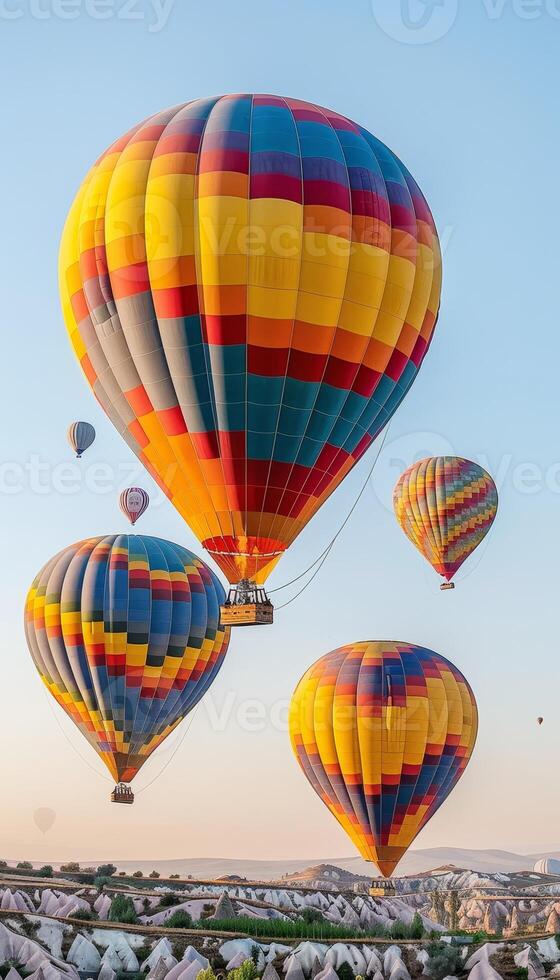 Vibrant hot air balloons drifting gracefully over the breathtaking mountainous scenery photo