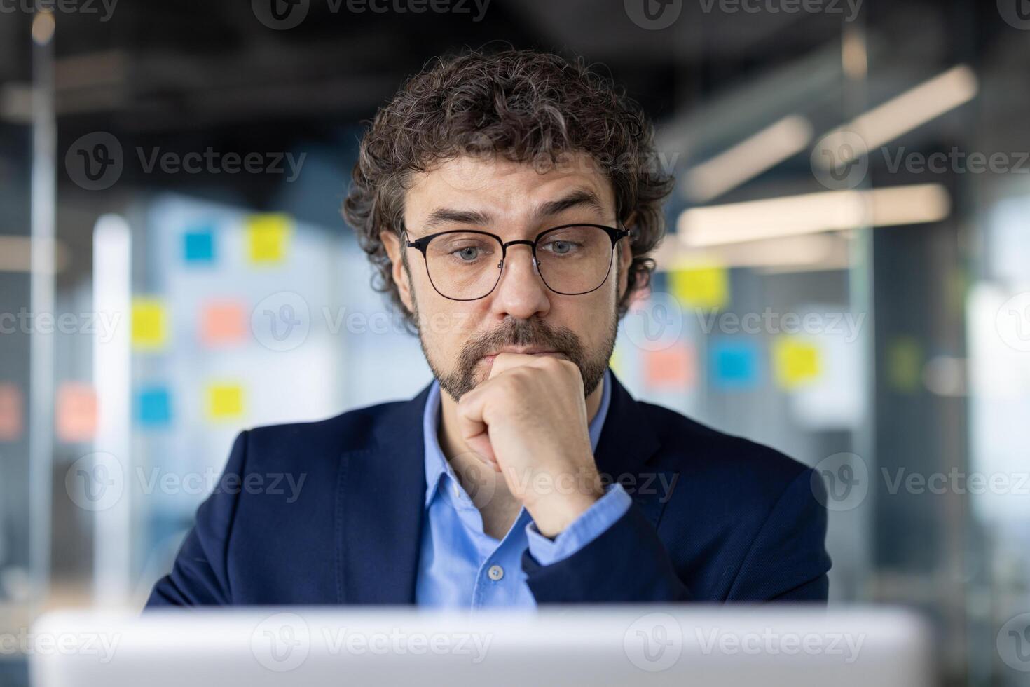 Close-up photo of serious thinking mature businessman, man thinking about the solution of daily work task inside office at workplace using laptop, company worker, boss in business suit.