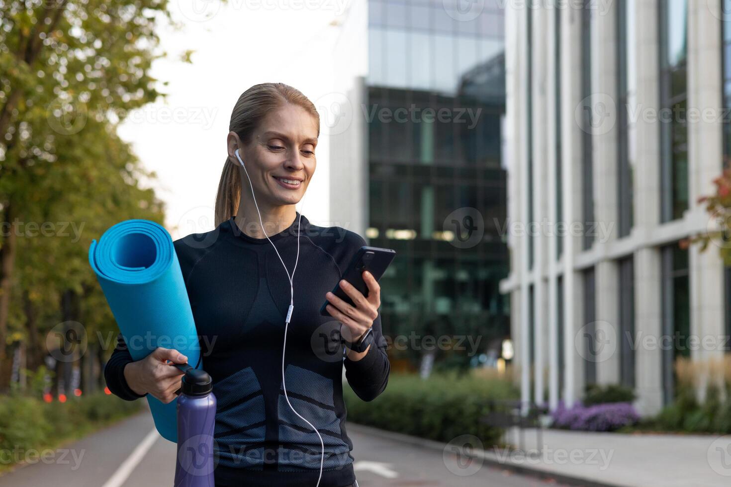 Joyful woman going to workout, athlete with yoga mat using online dating app and joint training. photo