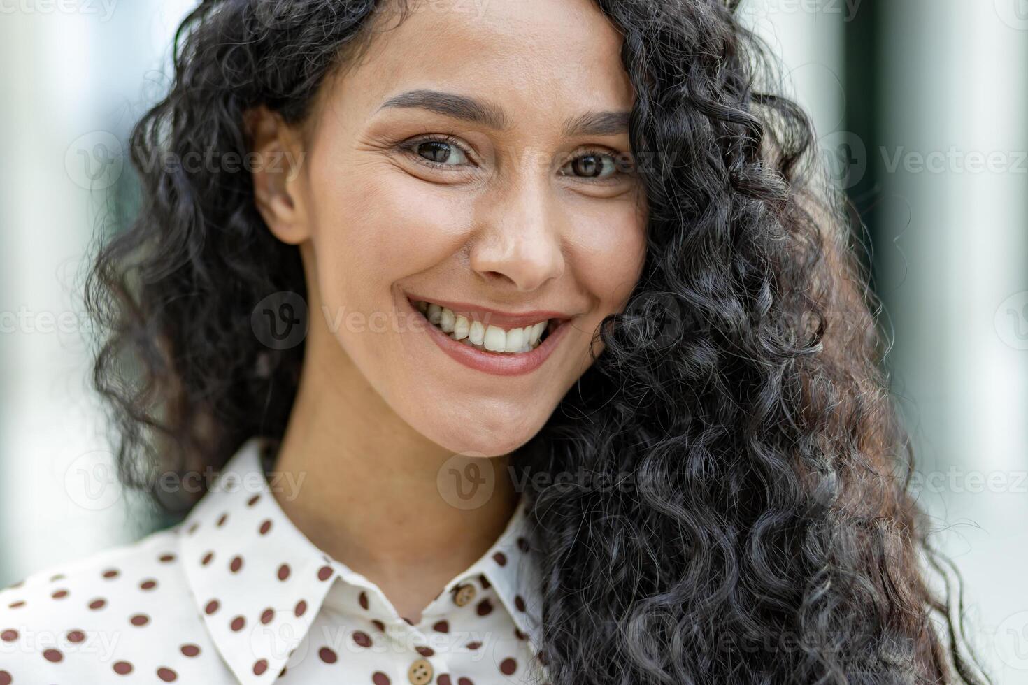 A detailed image showcasing the texture and pattern of curly hair and a polka-dotted garment. The soft focus gives the picture a delicate and stylish look suitable for diverse uses. photo