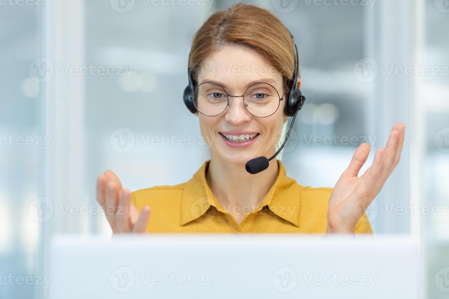 Closeup of successful businesswoman working remotely from home, worker of online logistics center of transportation smiling and consulting customers, woman in shirt working office sitting by window. photo