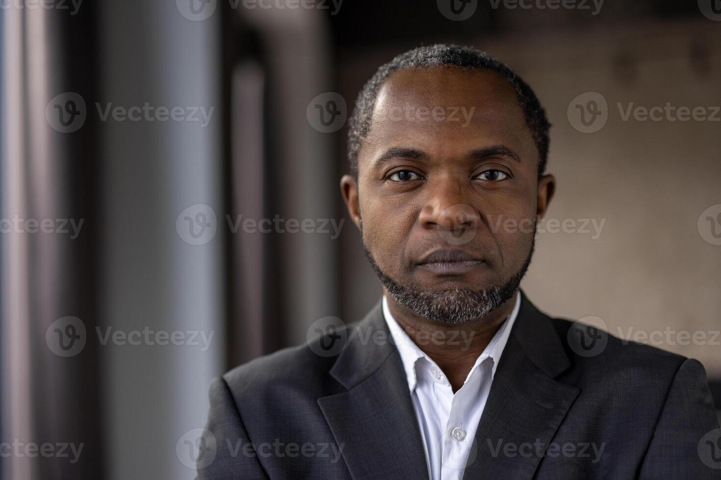 Close-up of a contemplative African American businessman in a suit, exuding professionalism and determination. photo