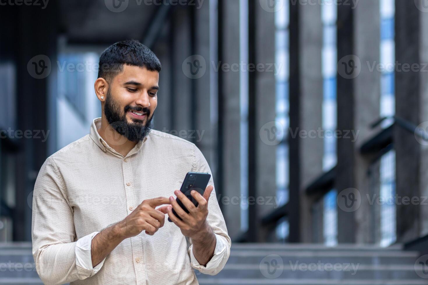 Smiling man using smartphone in urban setting, happy and connected photo