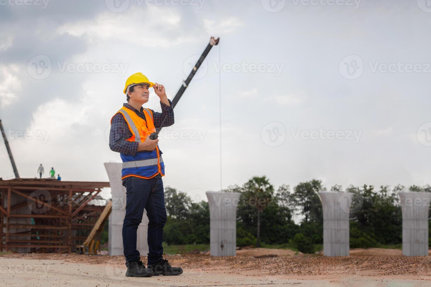 Foreman worker checking project at building site, Engineer, and builders in hardhats on construction site photo