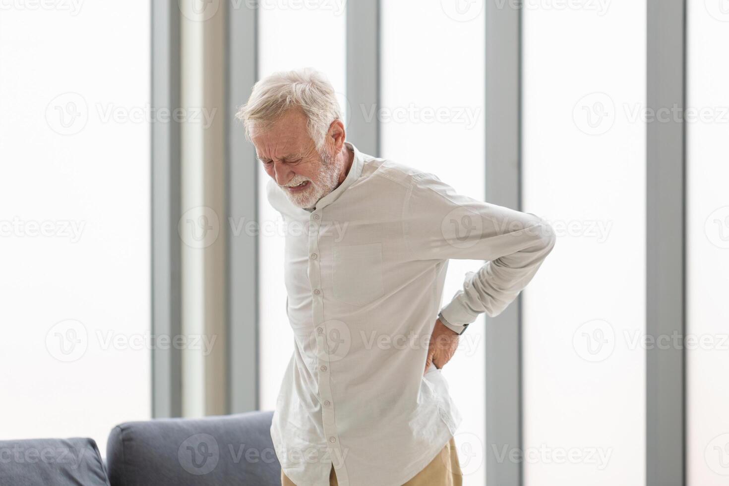 Senior man with back pain, Mature man suffering from low back pain, Old man with back pain photo
