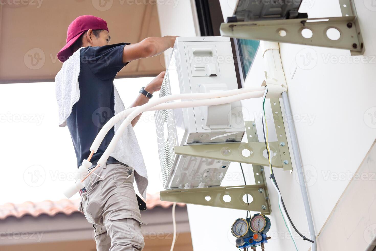 Repairman service for repair and maintenance of air conditioners, Technician man install new air conditioner photo