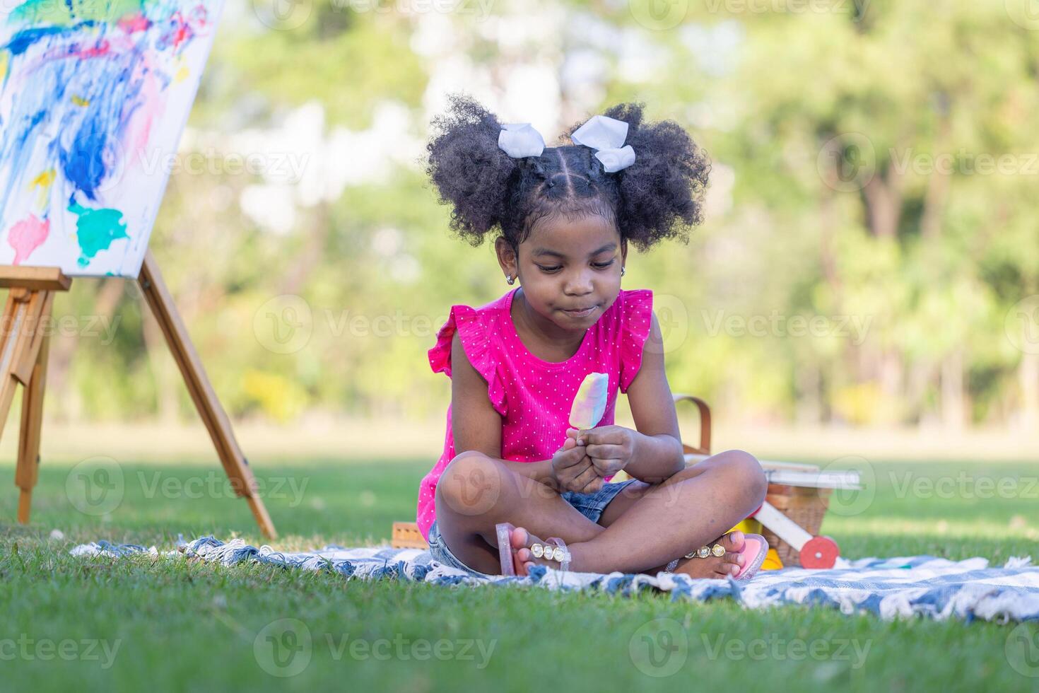 Child girl playing outdoors, Cute little girl play in the garden, Pretty baby girl kid eating ice cream photo