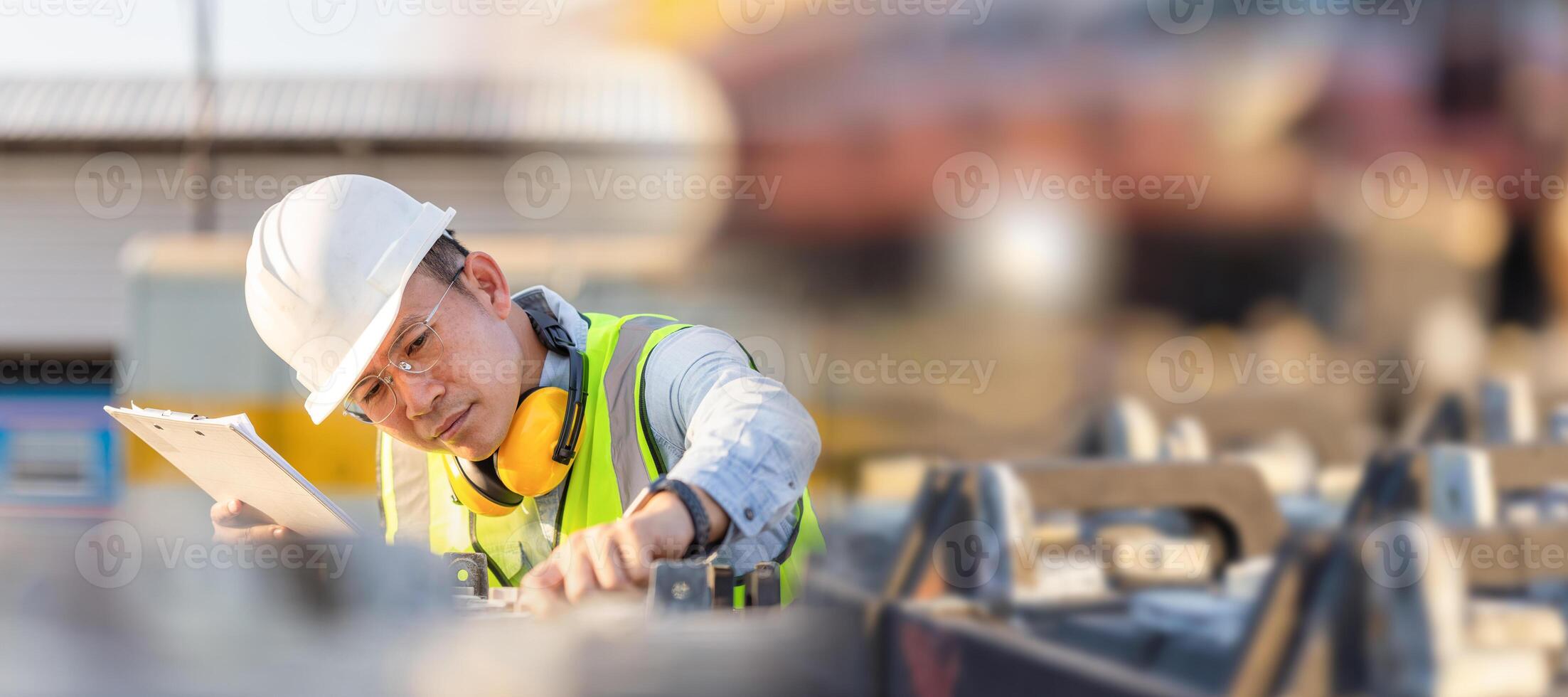 Engineer man in waistcoats and hardhats with documents inspecting construction site, Mechanical worker checking of the battery storage system photo