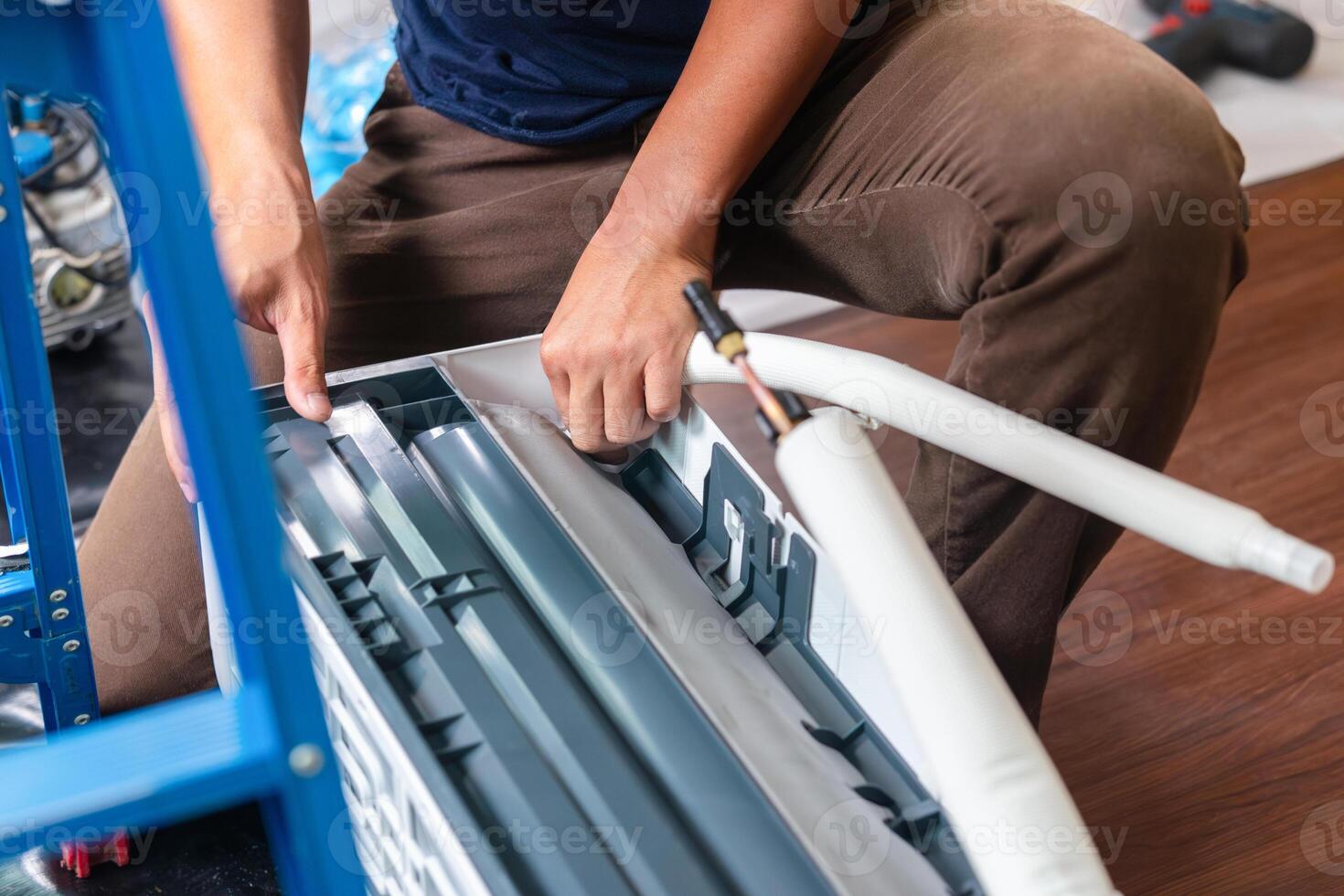 Repairman service for repair and maintenance of air conditioners, Technician team install new air conditioner photo