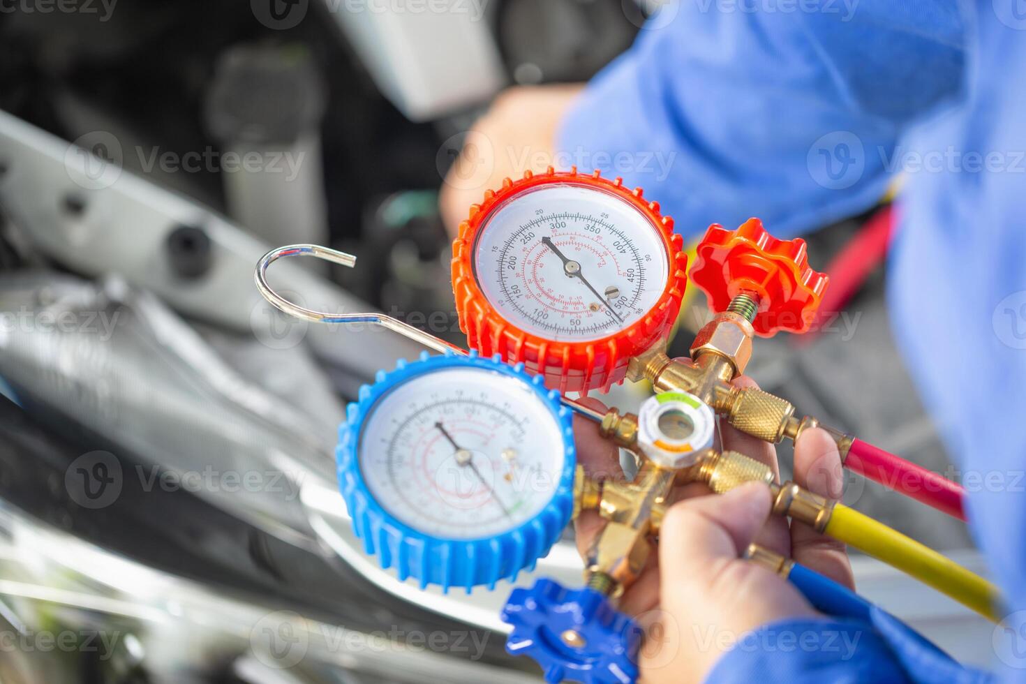 Repairman holding monitor tool to check and fixed car air conditioner system, Technician check car air conditioning system refrigerant recharge, Air Conditioning Repair photo