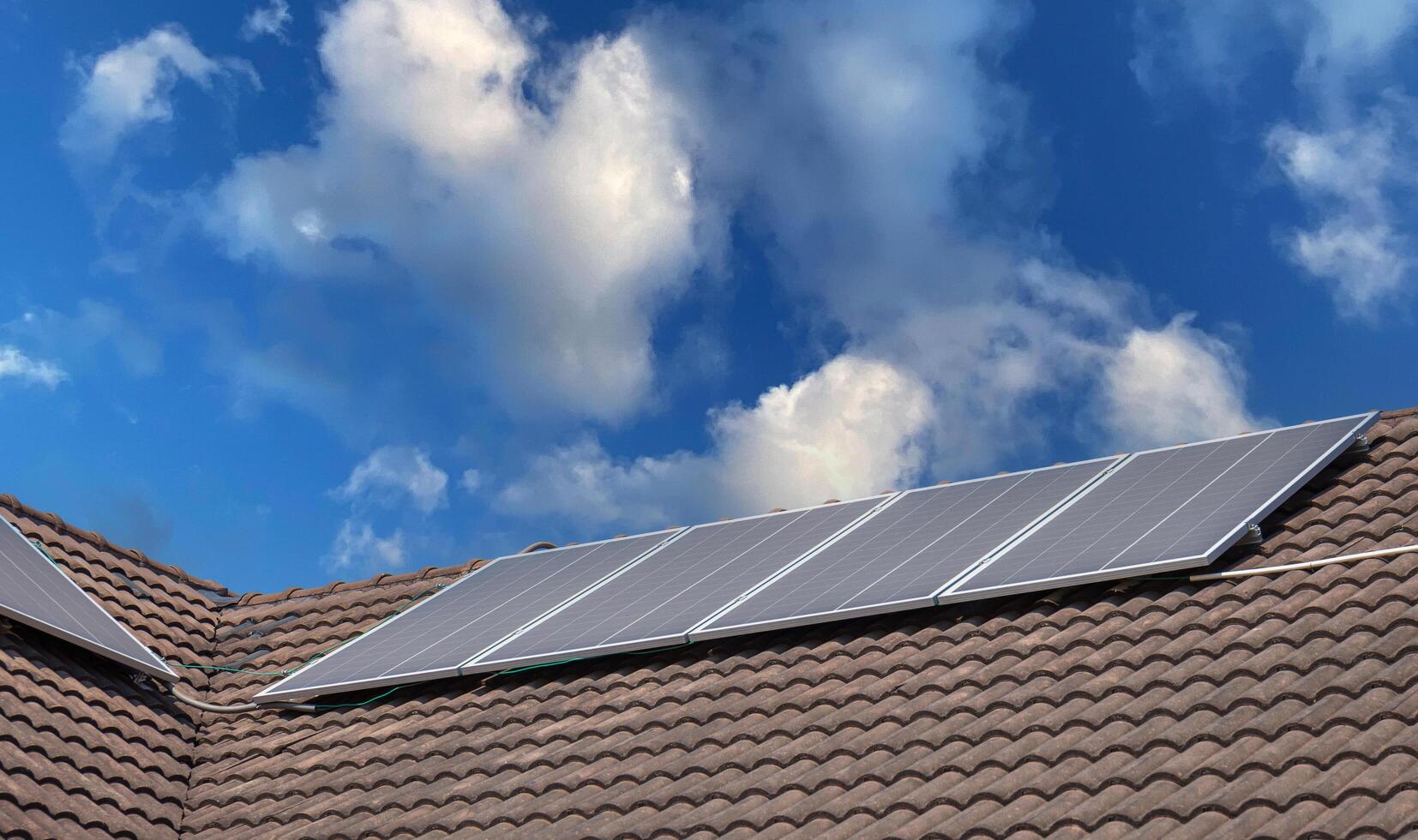 Solar panels on roofs with blue sky, Houses with solar panels, Modern eco green house concepts photo