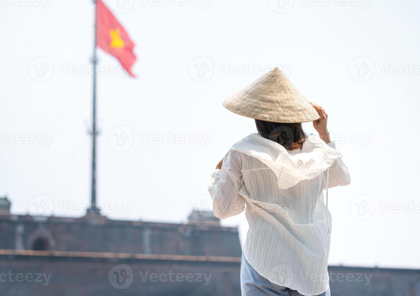 Back view of young woman traveler traveling in Vietnam, Tourist woman enjoys sightseeing at Hue Imperial in Vietnam photo