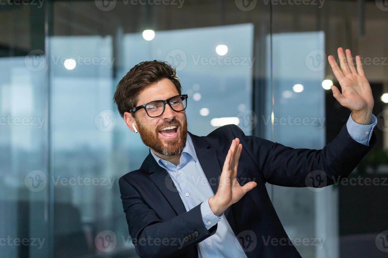 Mature successful manager boss celebrating good achievement and good work result, man dancing at workplace inside office, businessman at work in business suit. photo