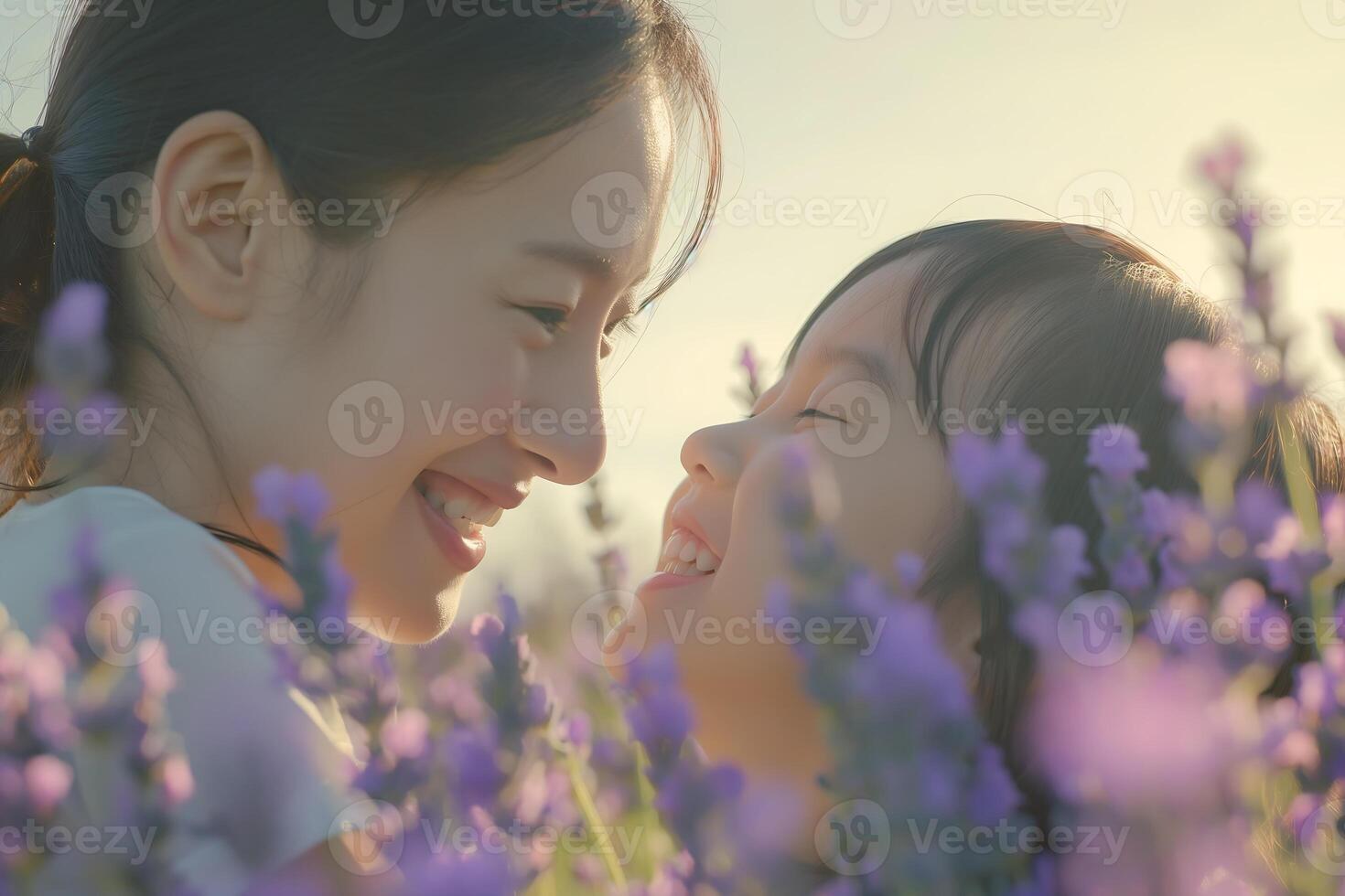 Asian woman and her child smile at each other with pure joy in the lavender flower field photo