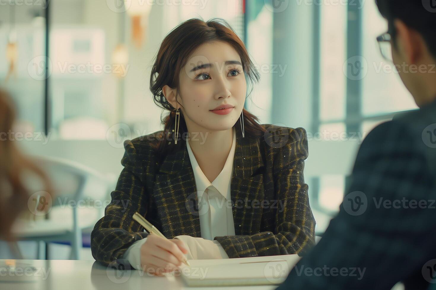 A manager is interviewing a prospective employee in the office photo