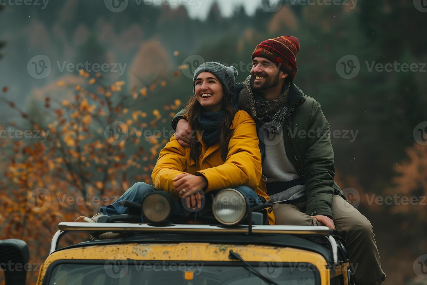 young couple happiness sits atop the sturdy hood of their off road vehicle photo
