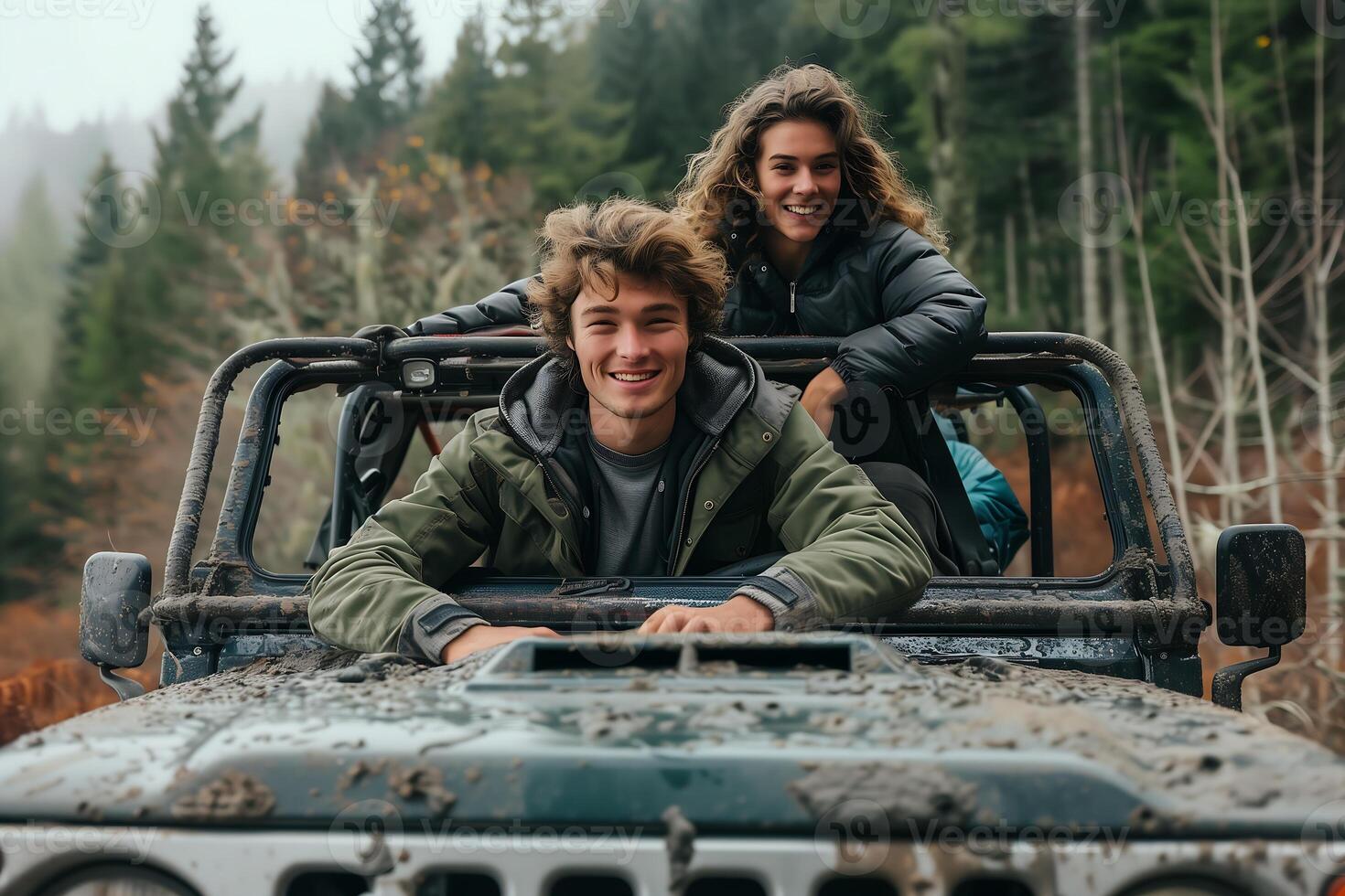 young couple happiness sits atop the sturdy hood of their off road vehicle photo