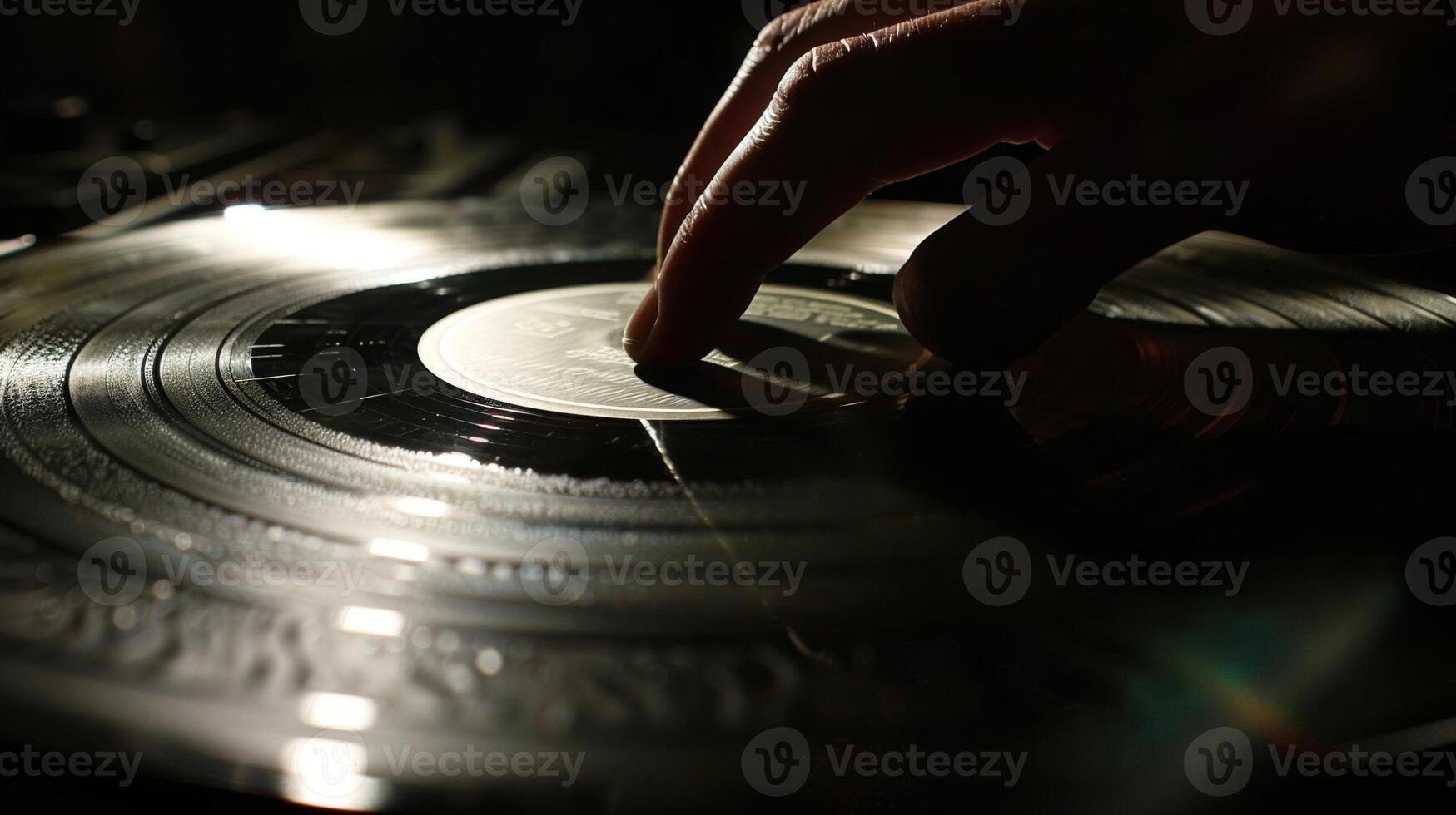 A hand holds a vinyl record up to the light admiring the intricate grooves etched into its surface photo