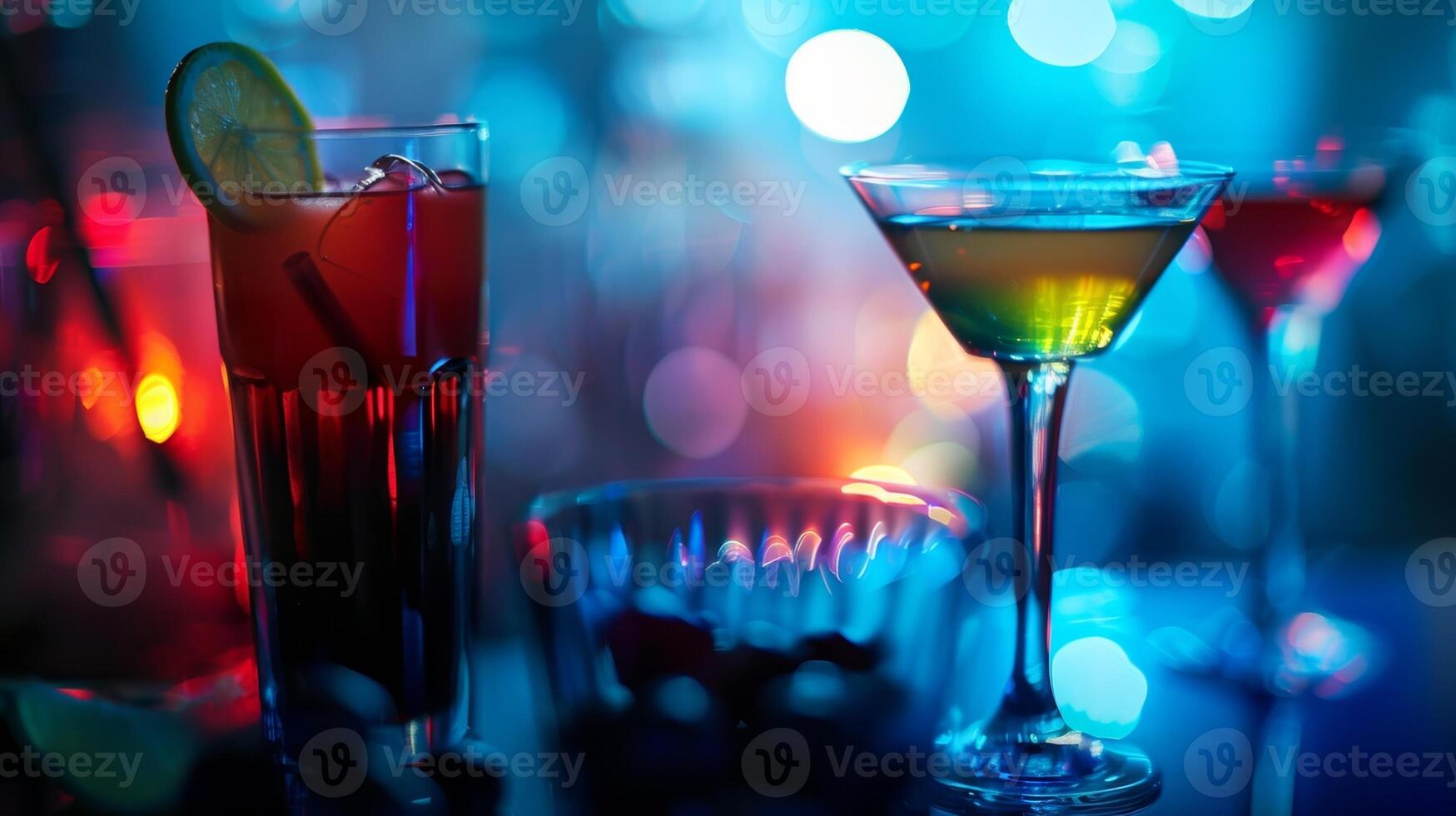 The subtle glow of the dimmed lights highlighting the sparkling glasses and vibrant colors of the handcrafted cocktails photo