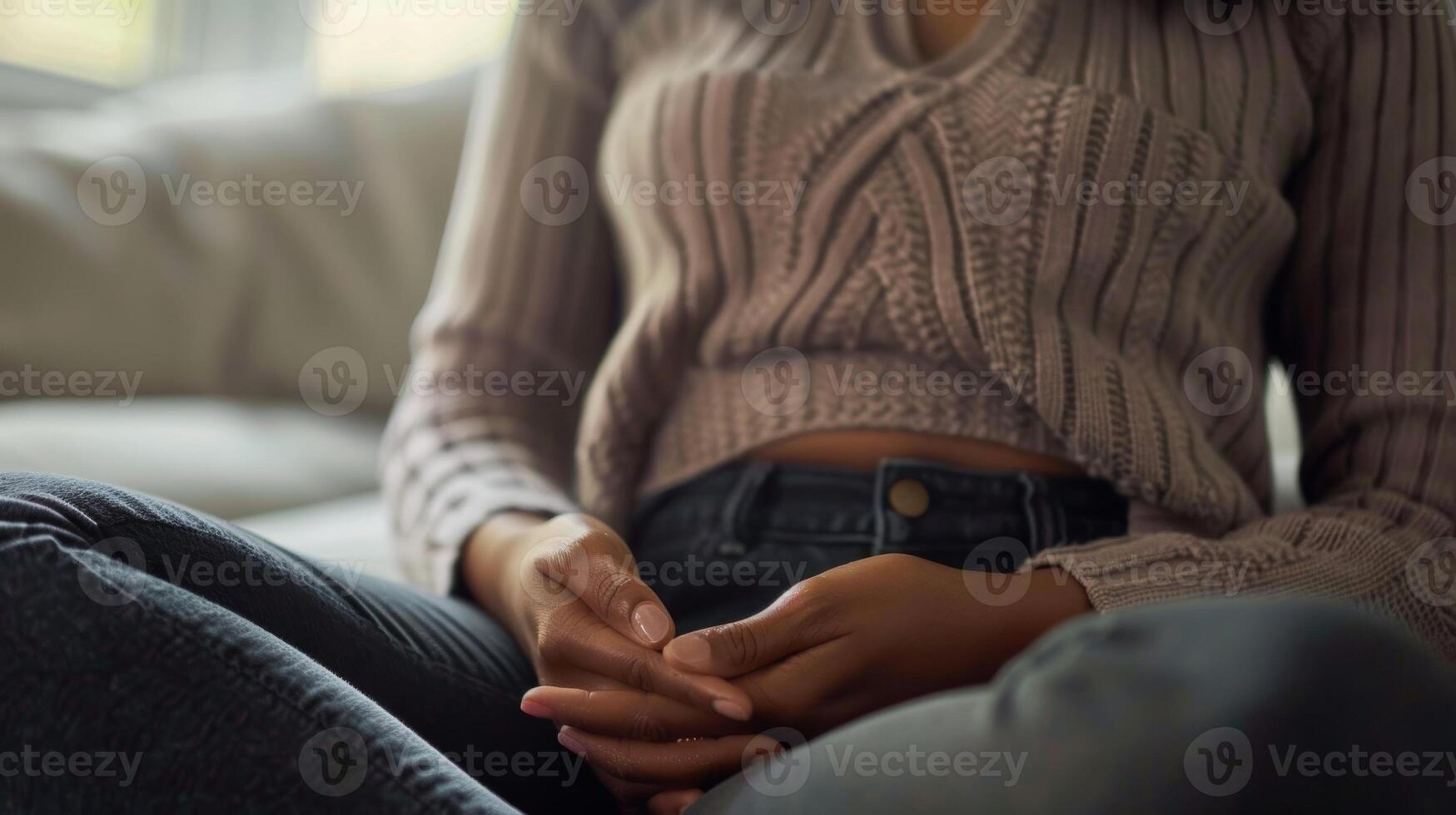 A close up image of a persons hands resting on their stomach as they concentrate on deep breathing with a quote about the importance of mindful breathing photo