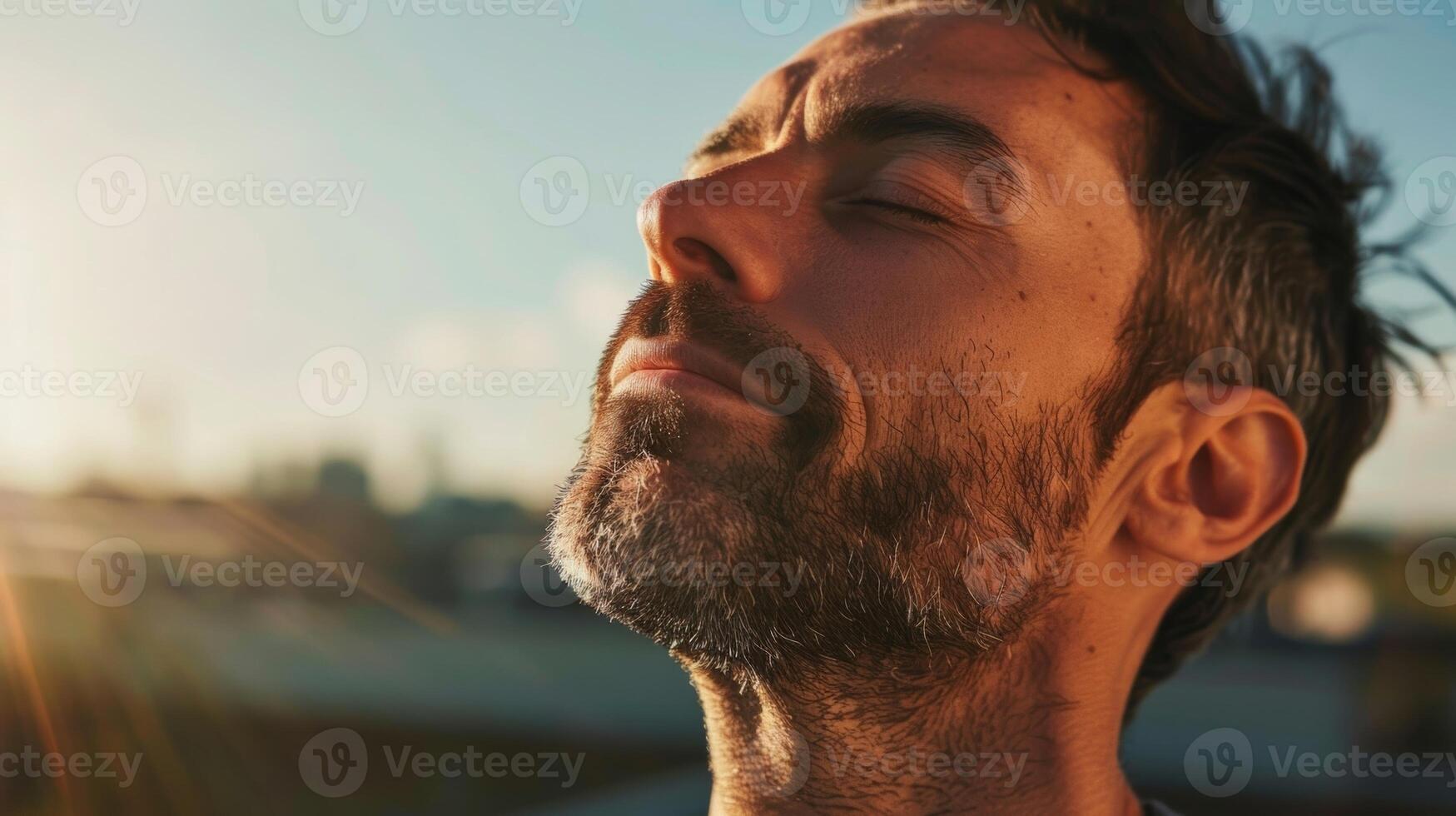 A man of average build practicing yoga on a rooftop his face expressing pure relaxation and selfcare photo