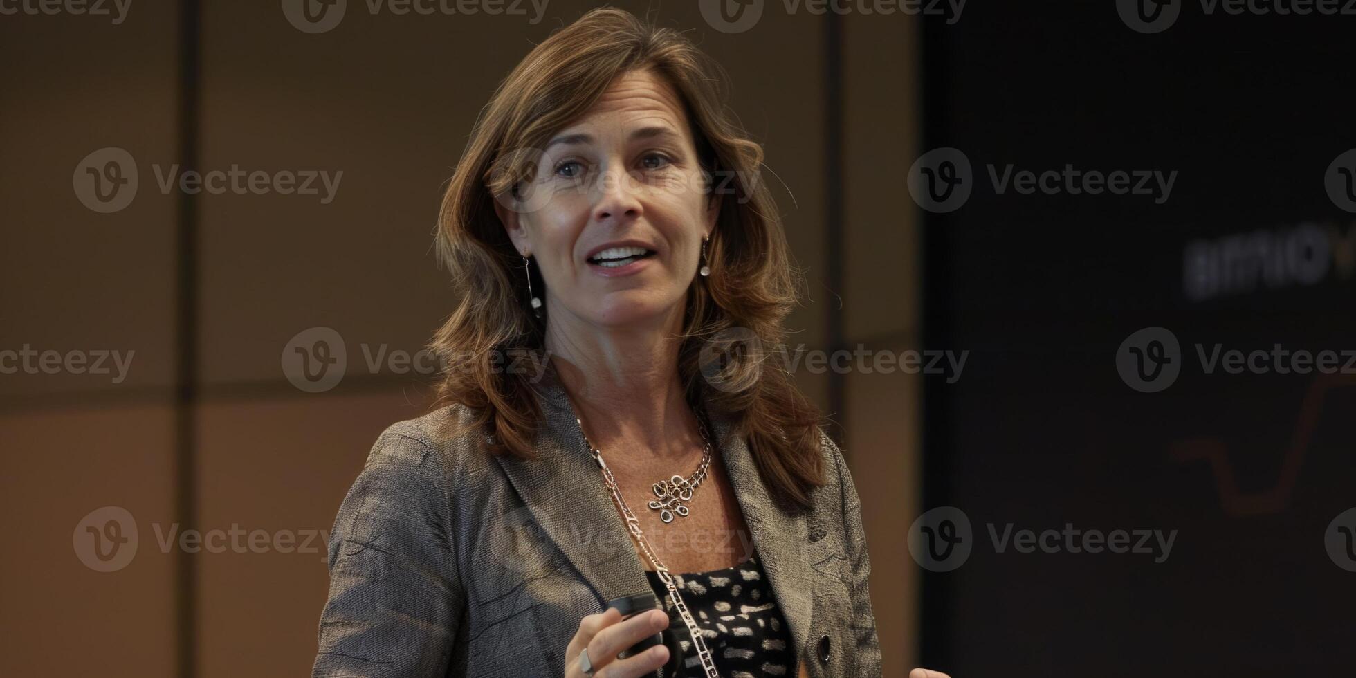speaking in the hall in front of an audience on the podium photo