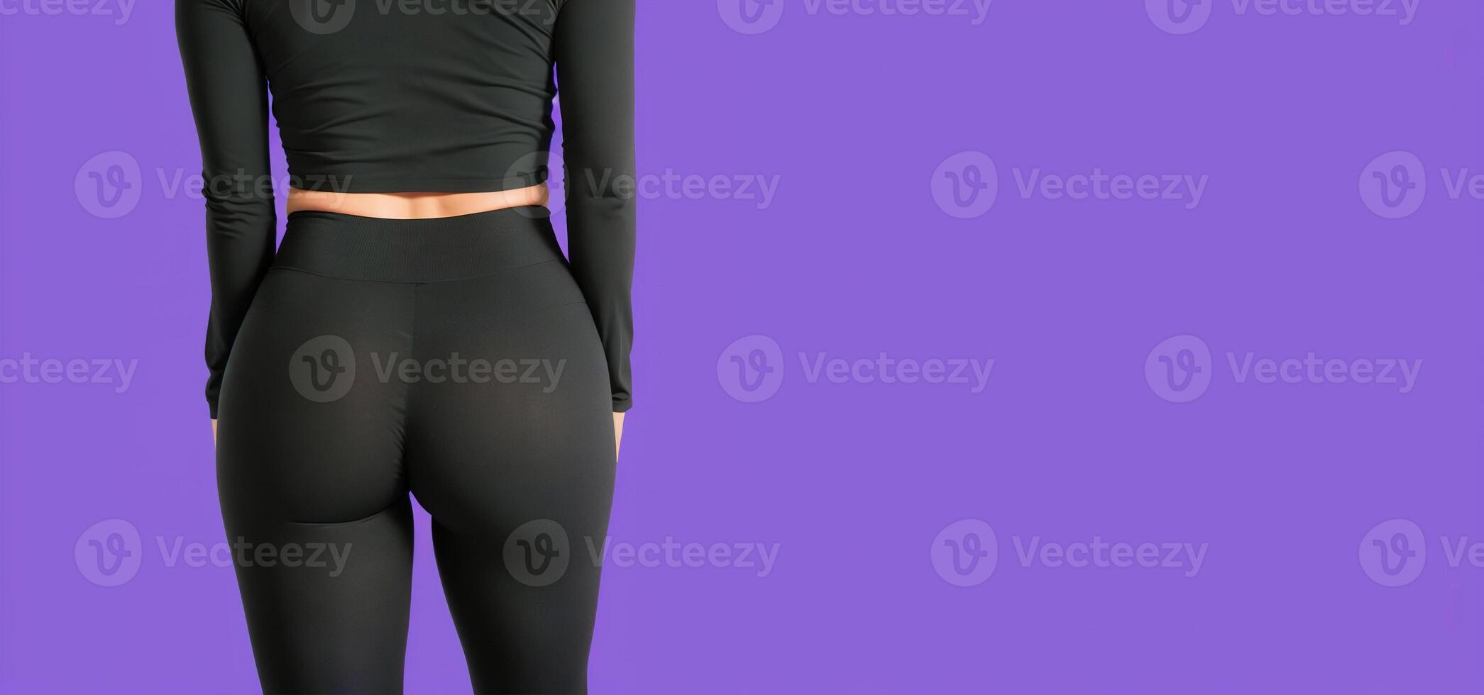 woman in black leggings on a purple background back view, photo
