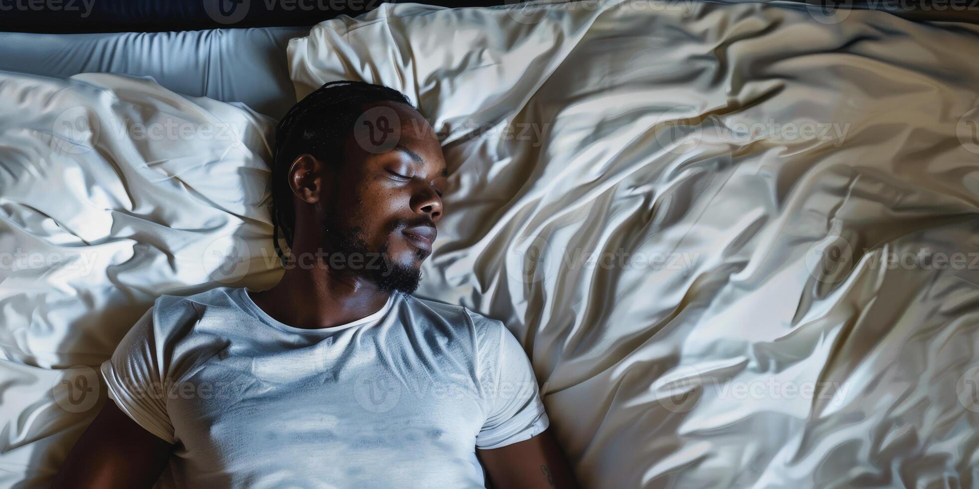 man sleeping in bed photo