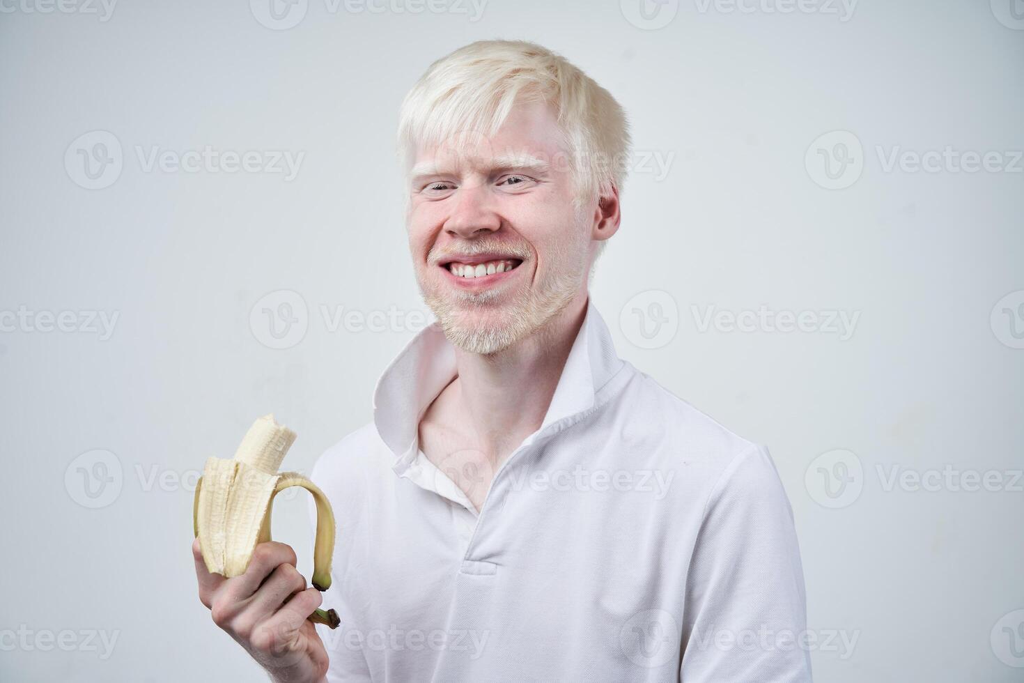 portrait of an albino man in studio dressed t-shirt isolated on a white background. abnormal deviations. unusual appearance photo