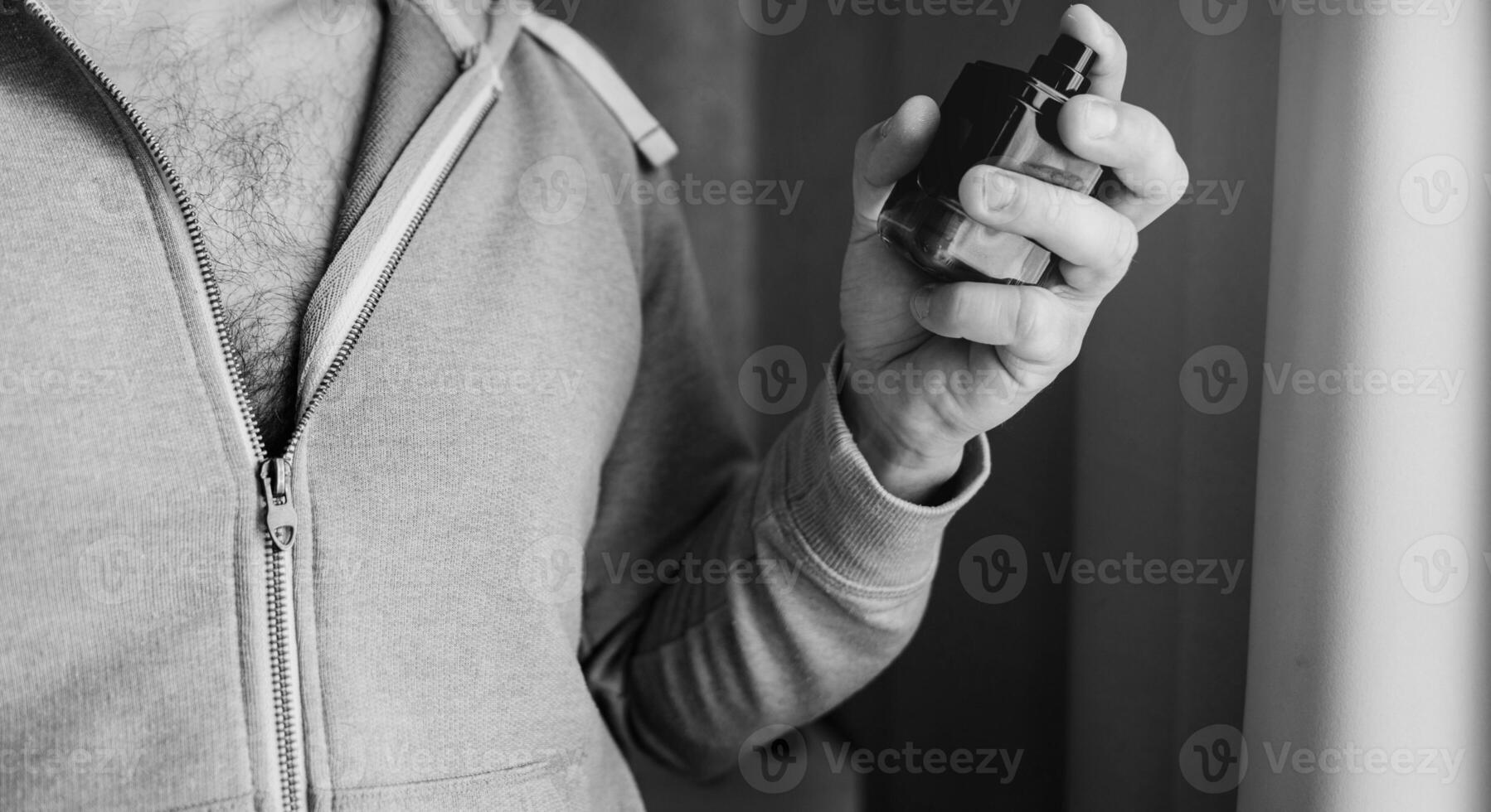 Man with a bottle of perfume photo