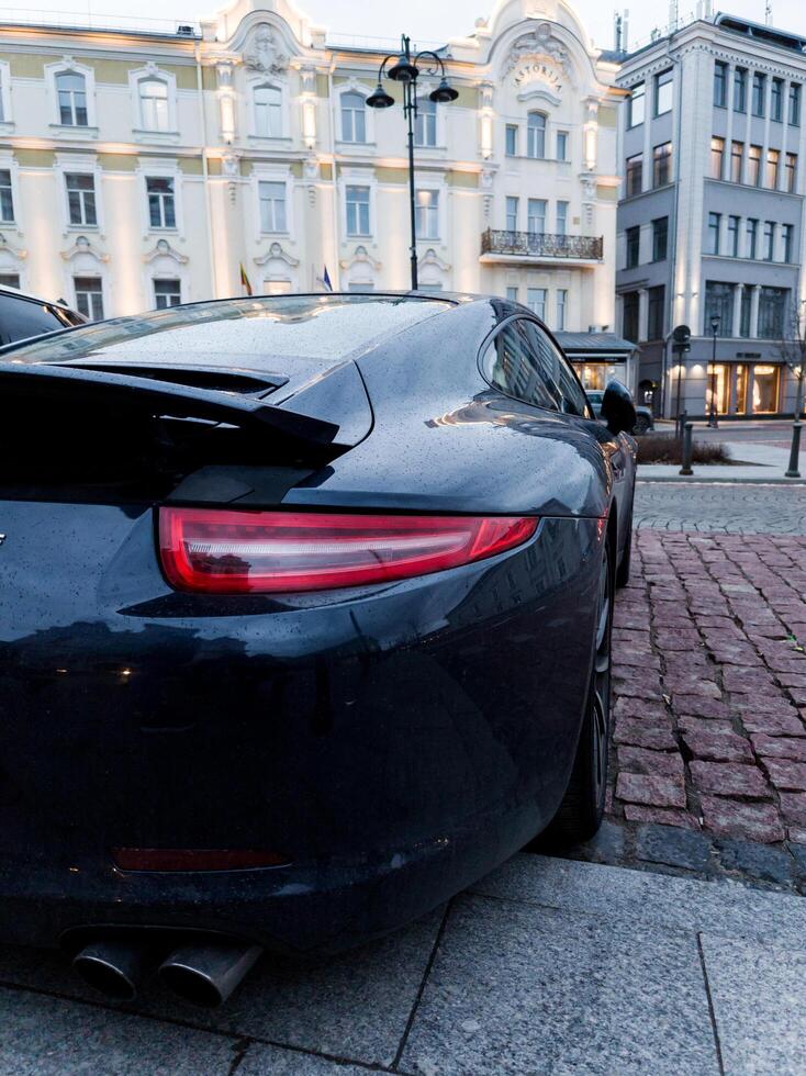 Lithuania, Vilnius, April 11, 2024 - Backlight expensive Porsche Carrera 911 photo