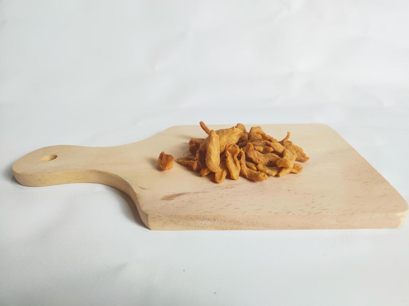 photography of cimi-cimi snacks on a wooden cutting board photo