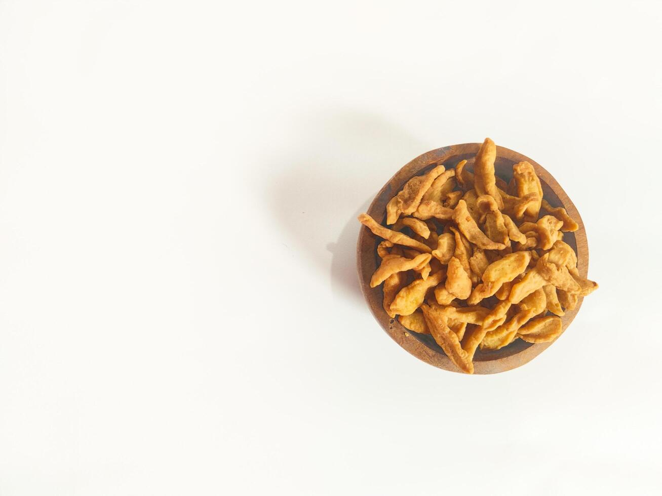 photography of cimi-cimi snack food in a wooden bowl on a white background photo