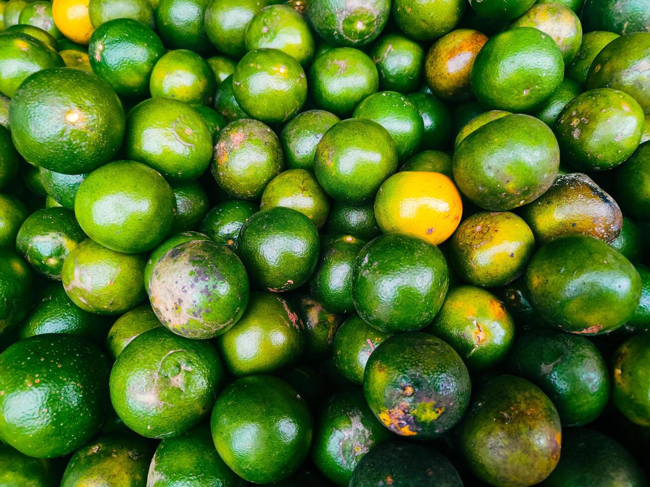 photography of close up texture background of pile of green orange fruit photo