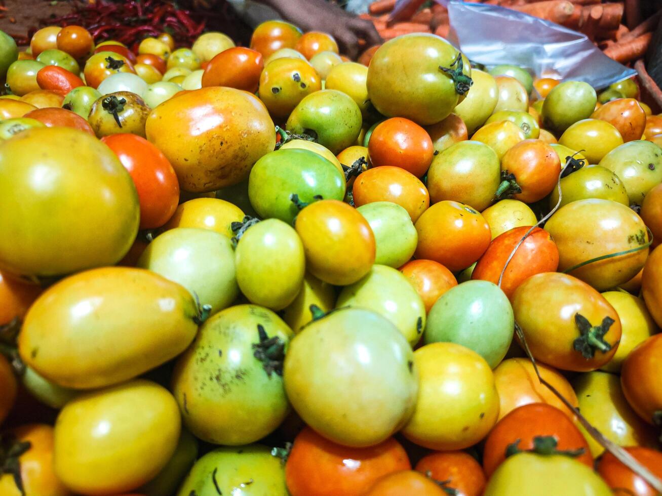 photography of close up texture background of pile of tomatoes photo