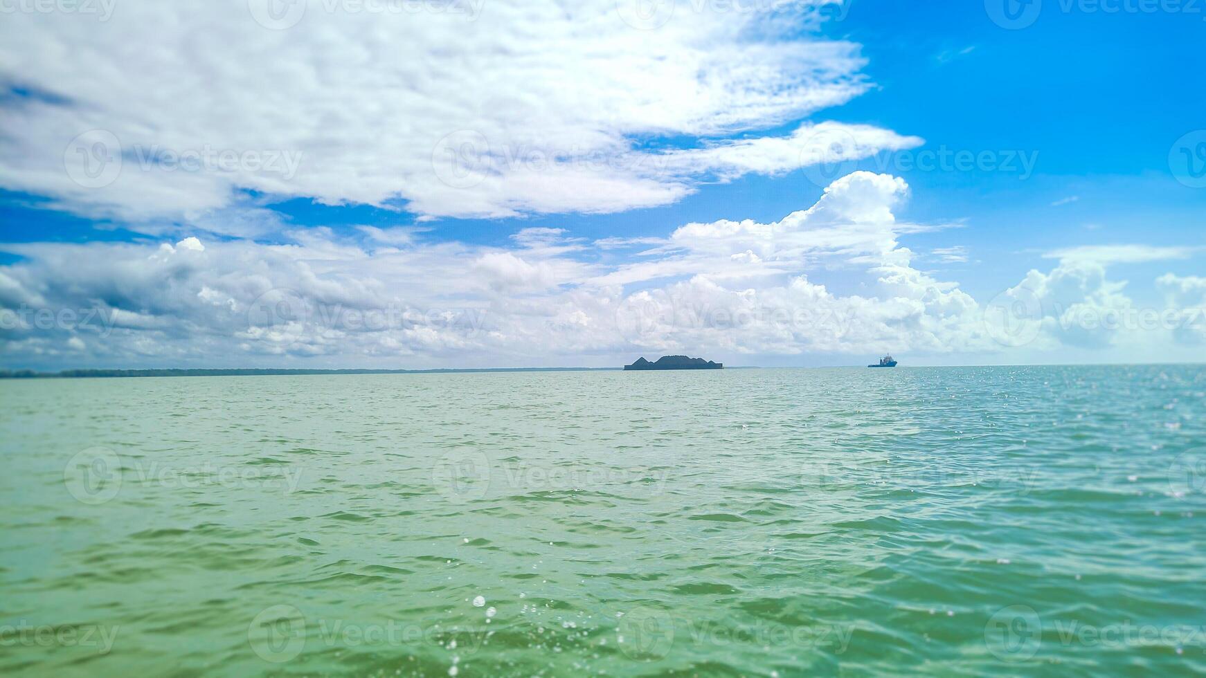landscape photography of ocean atmosphere with a bright blue sky background photo